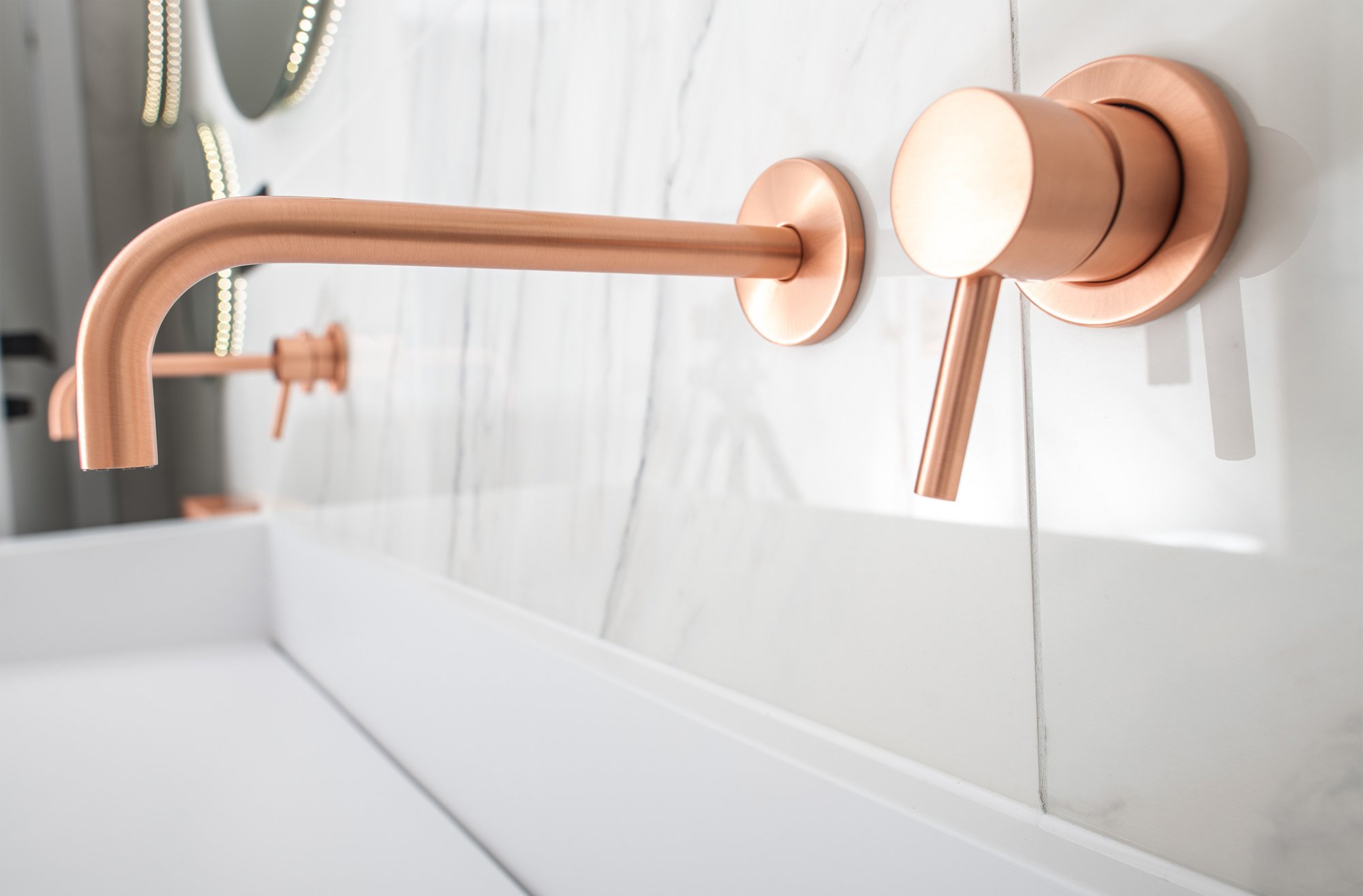 Lavish White Sink with Copper Fixtures